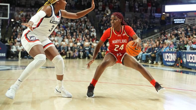 Nov 16, 2023; Storrs, Connecticut, USA; Maryland Terrapins guard Bri McDaniel (24) dribbles the ball against Connecticut Huskies forward Aaliyah Edwards (3) during the first half at Harry A. Gampel Pavilion. Mandatory Credit: Gregory Fisher-USA TODAY Sports