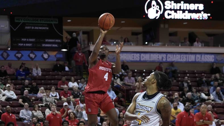Nov 16, 2023; Charleston, South Carolina, USA; Houston Cougars guard LJ Cryer (4) shoots the ball over Towson Tigers guard Dylan Williamson (4) in the second half at TD Arena. Mandatory Credit: David Yeazell-USA TODAY Sports