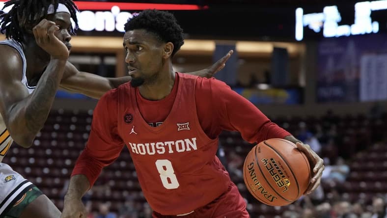 Nov 16, 2023; Charleston, South Carolina, USA; Houston Cougars guard Mylik Wilson (8) drives the ball in the second half against the Towson Tigers at TD Arena. Mandatory Credit: David Yeazell-USA TODAY Sports