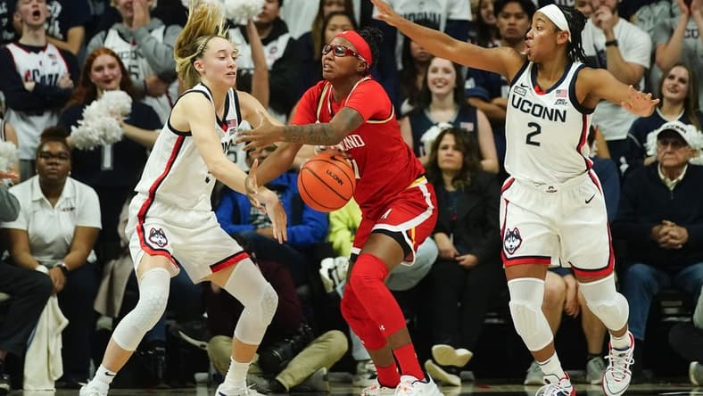 Nov 16, 2023; Storrs, Connecticut, USA; Connecticut Huskies guard Paige Bueckers (5) and Maryland Terrapins guard Jakia Brown-Turner (11) battle for a loose ball during the second half at Harry A. Gampel Pavilion. Mandatory Credit: Gregory Fisher-USA TODAY Sports