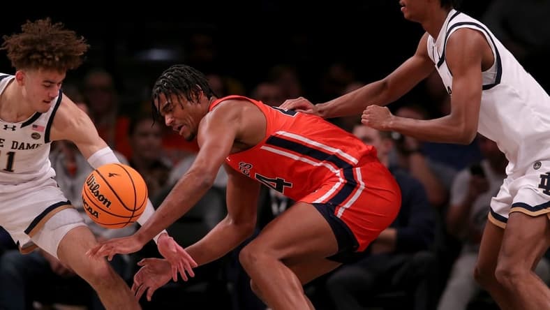 Nov 16, 2023; Brooklyn, New York, USA; Auburn Tigers center Dylan Cardwell (44) fights for the ball against Notre Dame Fighting Irish guard Braeden Shrewsberry (11) and forward Carey Booth (0) during the first half at Barclays Center. Mandatory Credit: Brad Penner-USA TODAY Sports