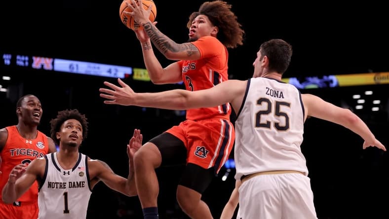 Nov 16, 2023; Brooklyn, New York, USA; Auburn Tigers guard Tre Donaldson (3) drives to the basket against Notre Dame Fighting Irish guard Julian Roper II (1) and forward Matt Zona (25) during the second half at Barclays Center. Mandatory Credit: Brad Penner-USA TODAY Sports