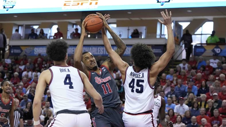Nov 17, 2023; Charleston, SC, USA; St. John's Red Storm center Joel Soriano (11) is fouled by Dayton Flyers forward Zimi Nwokeji (45) in the first half at TD Arena. Mandatory Credit: David Yeazell-USA TODAY Sports
