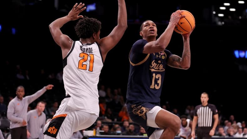 Nov 17, 2023; Brookyln, NY, USA; Notre Dame Fighting Irish forward Tae Davis (13) looks to shoot the ball against Oklahoma State Cowboys forward Justin McBride (21) during the first half at Barclays Center. Mandatory Credit: Brad Penner-USA TODAY Sports