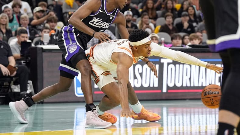 Nov 17, 2023; San Antonio, Texas, USA; Sacramento Kings guard De'Aaron Fox (5) and and San Antonio Spurs forward Keldon Johnson (3) battle for the loose ball during the first half at Frost Bank Center. Mandatory Credit: Scott Wachter-USA TODAY Sports