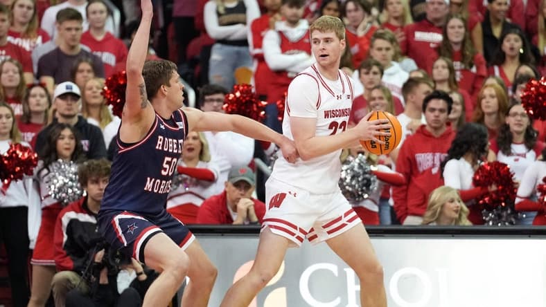 Nov 17, 2023; Madison, Wisconsin, USA; Wisconsin Badgers forward Steven Crowl (22) looks to the basket under coverage by Robert Morris Colonials forward Trey James (50) during the first half at the Kohl Center. Mandatory Credit: Kayla Wolf-USA TODAY Sports