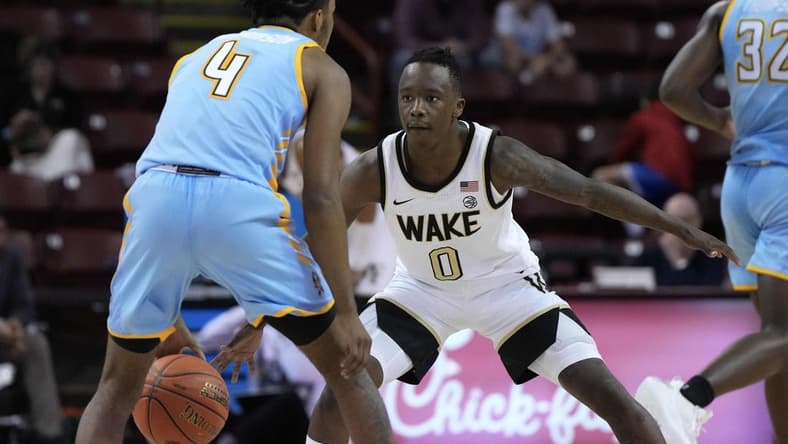 Nov 17, 2023; Charleston, SC, USA; Wake Forest Demon Deacons guard Kevin Miller (0) defends against Towson Tigers guard Dylan Williamson (4) in the second half at TD Arena. Mandatory Credit: David Yeazell-USA TODAY Sports