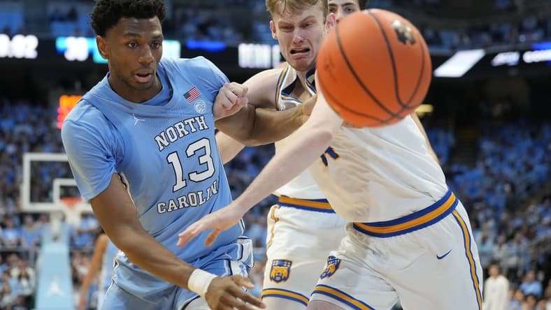 Nov 17, 2023; Chapel Hill, North Carolina, USA; North Carolina Tar Heels forward Jalen Washington (13) and UC Riverside Highlanders forward Wil Tattersall (14) fight for the ball in the first half at Dean E. Smith Center. Mandatory Credit: Bob Donnan-USA TODAY Sports