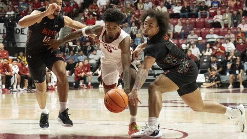 Nov 17, 2023; Tuscaloosa, Alabama, USA;  Alabama guard Aaron Estrada splits between Mercer forward TJ Grant (14) and Mercer guard Jah Quinones (0) at Coleman Coliseum. Mandatory Credit: Gary Cosby Jr.-USA TODAY Sports