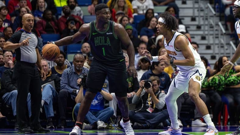 Nov 17, 2023; New Orleans, Louisiana, USA;  New Orleans Pelicans forward Zion Williamson (1) dribbles against Denver Nuggets forward Zeke Nnaji (22) during the first half at the Smoothie King Center. Mandatory Credit: Stephen Lew-USA TODAY Sports