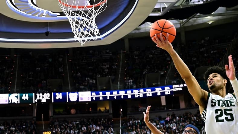 Nov 17, 2023; East Lansing, Michigan, USA; Michigan State Spartans forward Malik Hall (25) puts a shot off the glass past Butler Bulldogs center Andre Screen (23) during the second half at Jack Breslin Student Events Center. Mandatory Credit: Dale Young-USA TODAY Sports
