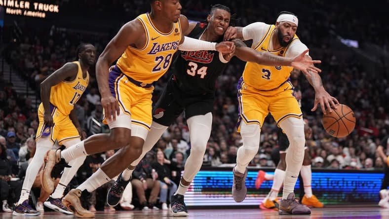 Nov 17, 2023; Portland, Oregon, USA; Portland Trail Blazers forward Jabari Walker (34) and Los Angeles Lakers power forward Rui Hachimura (28) and Anthony Davis (3) go after a loose ball during the first half at Moda Center. Mandatory Credit: Soobum Im-USA TODAY Sports