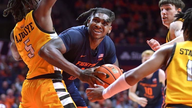 Nov 17, 2023; Champaign, Illinois, USA; Illinois Fighting Illini forward Dain Dainja (42) moves around Valparaiso Beacons forward Ola Ajiboye (5) as he drives to the basket during the first half at State Farm Center. Mandatory Credit: Ron Johnson-USA TODAY Sports