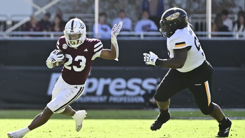 Nov 18, 2023; Starkville, Mississippi, USA; Mississippi State Bulldogs running back Seth Davis (23) runs the ball while defended by Southern Miss Golden Eagles defensive tackle Josh Ratcliff (93) during the second quarter at Davis Wade Stadium at Scott Field. Mandatory Credit: Matt Bush-USA TODAY Sports