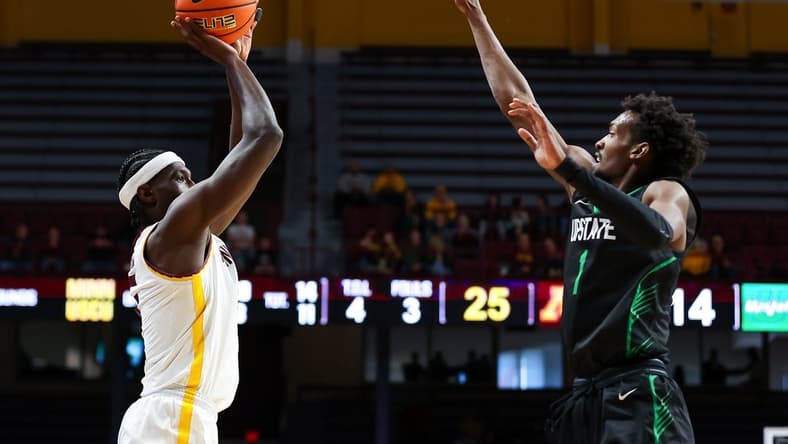 Nov 18, 2023; Minneapolis, Minnesota, USA; Minnesota Golden Gophers forward Isaiah Ihnen (5) shoots while USC Upstate Spartans guard Nick Alves (1) defends during the first half at Williams Arena. Mandatory Credit: Matt Krohn-USA TODAY Sports