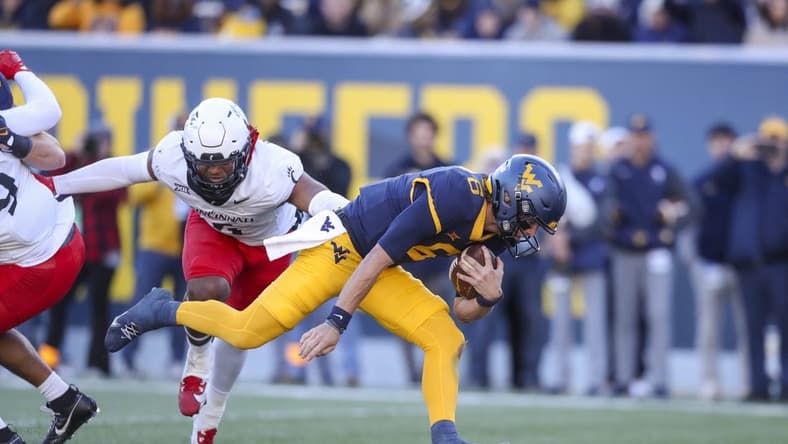 Nov 18, 2023; Morgantown, West Virginia, USA; West Virginia Mountaineers quarterback Garrett Greene (6) runs the ball for a touchdown during the first quarter against the Cincinnati Bearcats at Mountaineer Field at Milan Puskar Stadium. Mandatory Credit: Ben Queen-USA TODAY Sports