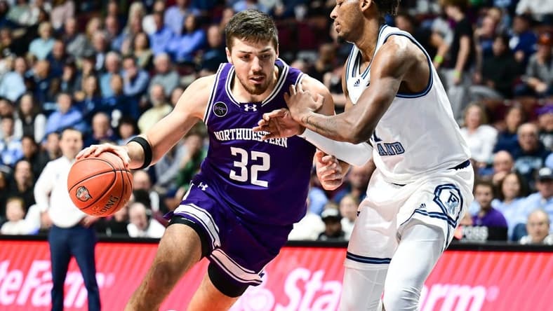 Nov 18, 2023; Uncasville, Connecticut, USA; Northwestern Wildcats forward Blake Preston (32) dribbles the ball defended by Rhode Island Rams guard Luis Kortright (1) during the second half at Mohegan Sun Arena. Mandatory Credit: Mark Smith-USA TODAY Sports