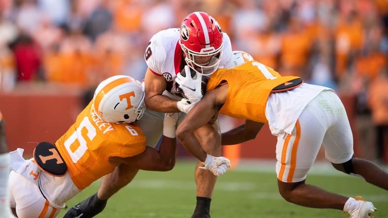 Georgia tight end Brock Bowers (19) is tackled by Tennessee linebacker Aaron Beasley (6) during a football game between Tennessee and Georgia at Neyland Stadium in Knoxville, Tenn., on Saturday, Nov. 18, 2023.