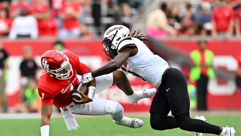 Nov 18, 2023; Houston, Texas, USA; Oklahoma State Cowboys safety Trey Rucker (9) tackles Houston Cougars quarterback Donovan Smith (1) during the first half at TDECU Stadium. Mandatory Credit: Maria Lysaker-USA TODAY Sports