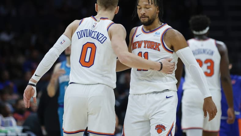 Nov 18, 2023; Charlotte, North Carolina, USA; New York Knicks guard Jalen Brunson (11) embraces guard Donte DiVincenzo (0) during the first quarter against the Charlotte Hornets at Spectrum Center. Mandatory Credit: Nell Redmond-USA TODAY Sports