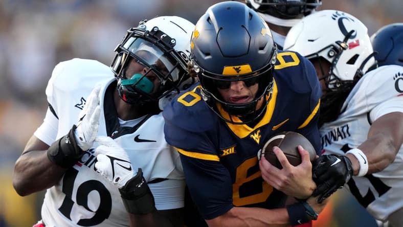 West Virginia Mountaineers quarterback Garrett Greene (6) carries the ball on a touchdown run in the third quarter during an NCAA college football game between the Cincinnati Bearcats and the West Virginia Mountaineers, Saturday, Nov. 18, 2023, at Milan Puskar Stadium in Morgantown, W. Va. The West Virginia Mountaineers won, 42-21.