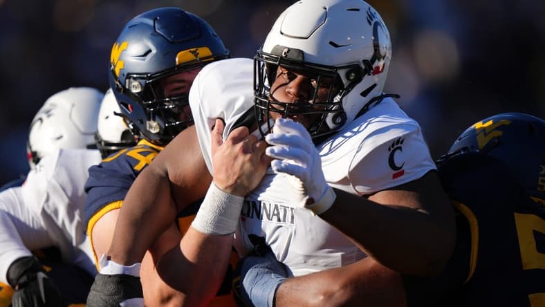 Nov 18, 2023; Morgantown, West Virginia, USA; Cincinnati Bearcats defensive lineman Dontay Corleone (2) is double-teamed on a pass rush against the West Virginia Mountaineers in the first quarter at Milan Puskar Stadium. Mandatory Credit: Kareem Elgazzar-USA TODAY Sports