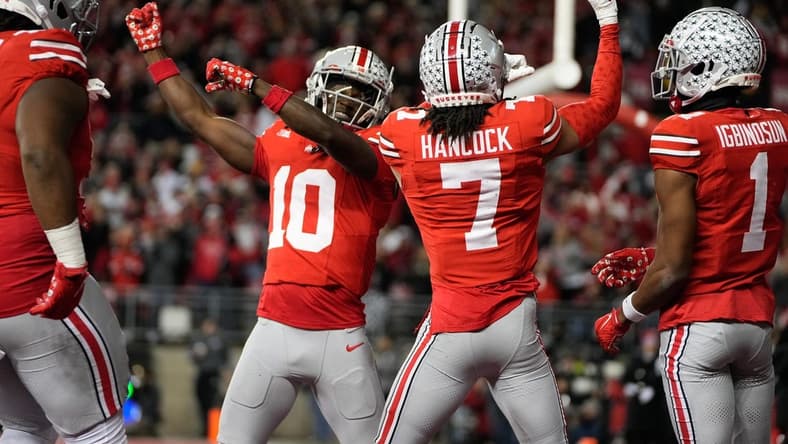 Nov 18, 2023; Columbus, Ohio, USA; Ohio State Buckeyes cornerback Jordan Hancock (7) and cornerback Denzel Burke (10) celebrate an interception by Hancock during the second half of the NCAA football game against the Minnesota Golden Gophers at Ohio Stadium. Ohio State won 37-3.