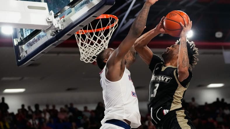 Nov 18, 2023; Boca Raton, Florida, USA;  Bryant University Bulldogs guard Sherif Gross-Bullock (3) shoots against Florida Atlantic Owls guard Johnell Davis (1) during the second half at Eleanor R. Baldwin Arena. Mandatory Credit: Rich Storry-USA TODAY Sports