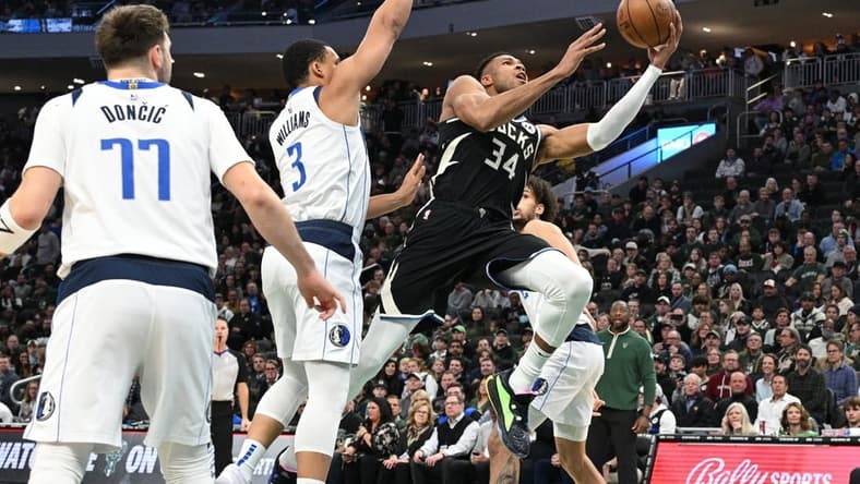 Nov 18, 2023; Milwaukee, Wisconsin, USA; Milwaukee Bucks forward Giannis Antetokounmpo (34) drives to the basket against Dallas Mavericks forward Grant Williams (3) in the first half at Fiserv Forum. Mandatory Credit: Michael McLoone-USA TODAY Sports
