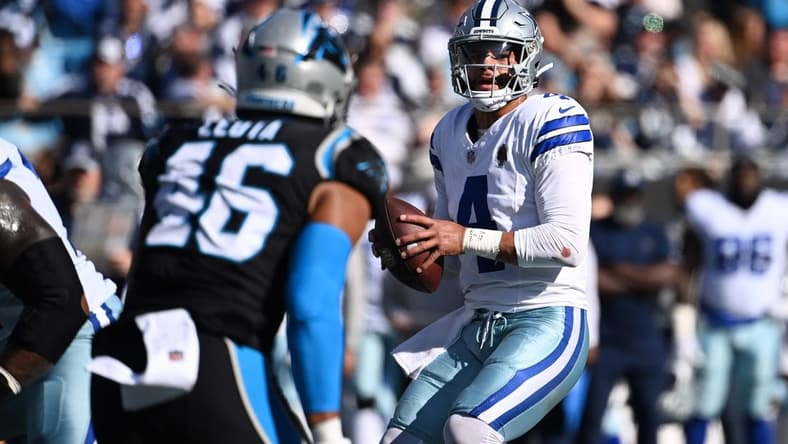 Nov 19, 2023; Charlotte, North Carolina, USA; Dallas Cowboys quarterback Dak Prescott (4) looks to pass as Carolina Panthers linebacker Eku Leota (46) defends in the second quarter at Bank of America Stadium. Mandatory Credit: Bob Donnan-USA TODAY Sports