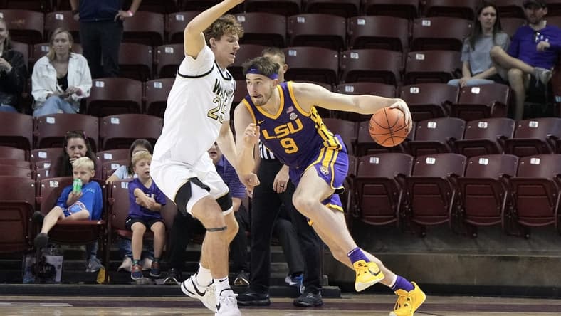 Nov 19, 2023; Charleston, SC, USA; LSU Tigers forward Will Baker (9) drives the ball around Wake Forest Demon Deacons forward Zach Keller (25) in the first half at TD Arena. Mandatory Credit: David Yeazell-USA TODAY Sports