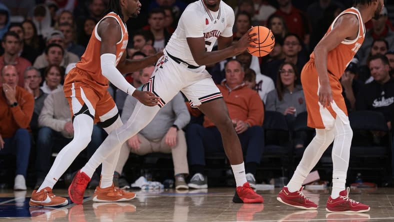 Nov 19, 2023; New York, New York, USA; Louisville Cardinals forward Brandon Huntley-Hatfield (5) is guarded by Texas Longhorns forward Ze'Rik Onyema (21) during the first half at Madison Square Garden. Mandatory Credit: Vincent Carchietta-USA TODAY Sports