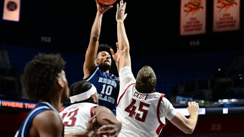 Nov 19, 2023; Uncasville, CT, USA; Washington State Cougars forward Oscar Cluff (45) jumps to block a shot by Rhode Island Rams forward Tyson Brown (10) during the first half at Mohegan Sun Arena. Mandatory Credit: Mark Smith-USA TODAY Sports