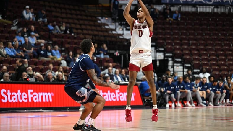 Nov 19, 2023; Uncasville, CT, USA; Washington State Cougars forward Jaylen Wells (0) shoots the ball over Rhode Island Rams guard Luis Kortright (1) during the second half at Mohegan Sun Arena. Mandatory Credit: Mark Smith-USA TODAY Sports