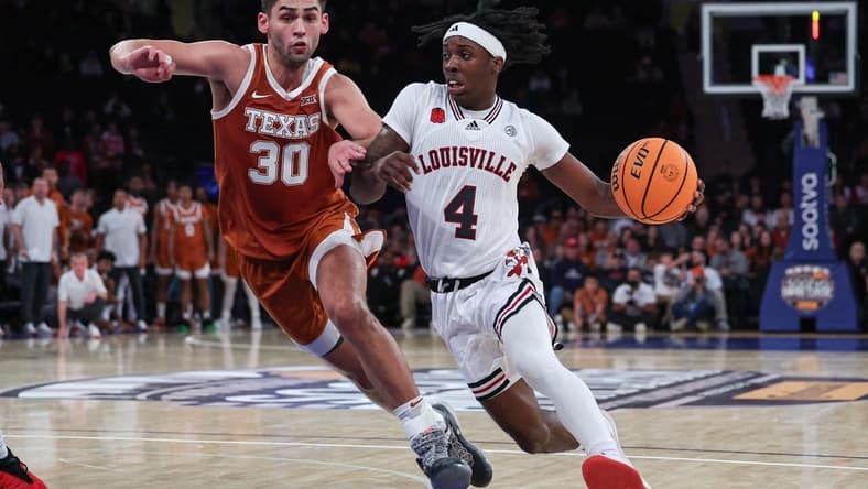 Nov 19, 2023; New York, New York, USA; Louisville Cardinals guard Ty-Laur Johnson (4) drives to the basket against Texas Longhorns forward Brock Cunningham (30) during the second half at Madison Square Garden. Mandatory Credit: Vincent Carchietta-USA TODAY Sports