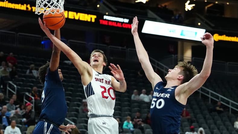Nov 19, 2023; Las Vegas, NV, USA; St. Mary's Gaels guard Aidan Mahaney (20) shoots between Xavier Musketeers guard Dailyn Swain (3) and forward Gytis Nemeiksa (50) during the first half at T-Mobile Arena. Mandatory Credit: Stephen R. Sylvanie-USA TODAY Sports