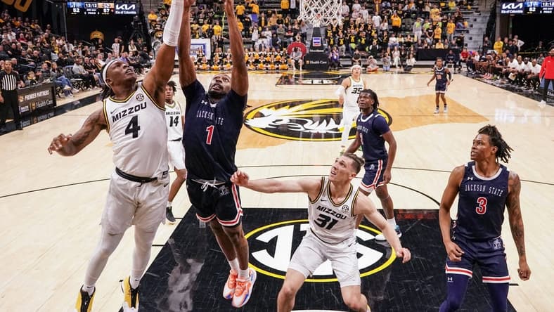 Missouri Tigers guard Curt Lewis (4) shoots a layup as Jackson State Tigers forward Zeke Cook (1) defends during the second half at Mizzou Arena. Mandatory Credit: Denny Medley-USA TODAY Sports
