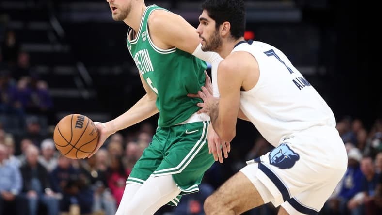 Nov 19, 2023; Memphis, Tennessee, USA; Boston Celtics center Kristaps Porzingis (8) passes as Memphis Grizzlies forward-center Santi Aldama (7) defends during the first half at FedExForum. Mandatory Credit: Petre Thomas-USA TODAY Sports