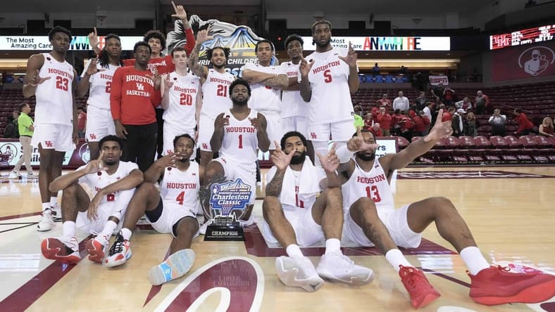 Nov 19, 2023; Charleston, SC, USA; The Houston Cougars with the champions trophy after winning the 2023 Charleston Classic at TD Arena. Mandatory Credit: David Yeazell-USA TODAY Sports
