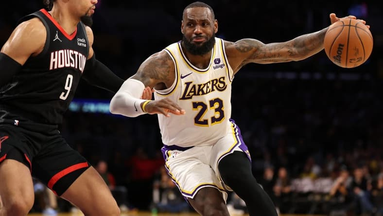 Nov 19, 2023; Los Angeles, California, USA;  Los Angeles Lakers forward LeBron James (23) dribbles against Houston Rockets forward Dillon Brooks (9) during the second quarter at Crypto.com Arena. Mandatory Credit: Kiyoshi Mio-USA TODAY Sports