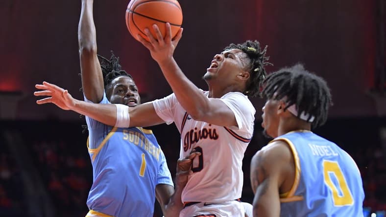 Nov 19, 2023; Champaign, Illinois, USA;  Illinois Fighting Illini guard Terrence Shannon Jr. (0) drives to the basket as Southern Jaguars forward JaRonn Wilkens (1) defends during the first half at State Farm Center. Mandatory Credit: Ron Johnson-USA TODAY Sports