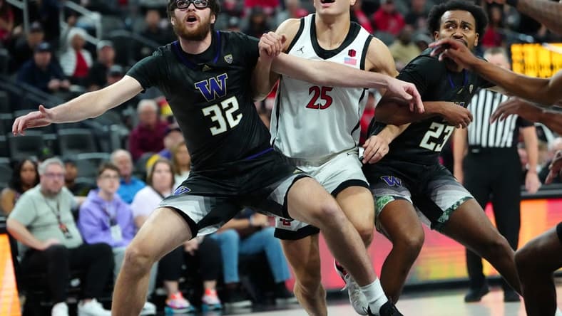 Nov 19, 2023; Las Vegas, NV, USA; San Diego State Aztecs forward Elijah Saunders (25) is blocked out by Washington Huskies forward Wilhelm Breidenbach (32) and guard Anthony Holland (23) during the first half at T-Mobile Arena. Mandatory Credit: Stephen R. Sylvanie-USA TODAY Sports