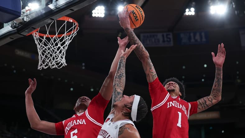 Nov 20, 2023; New York, NY, USA; Louisville Cardinals guard Tre White (22) rebounds against Indiana Hoosiers forward Malik Reneau (5) and center Kel'el Ware (1) during the first half at Madison Square Garden. Mandatory Credit: Vincent Carchietta-USA TODAY Sports