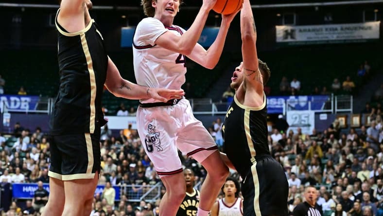 Nov 20, 2023; Honolulu, Hawaii, USA;  Gonzaga Bulldogs guard Dusty Stromer (4) drives to the basket defended by Purdue Boilermakers center Zach Edey (15) and forward Mason Gillis (0) during the second half at SimpliFi Arena at Stan Sheriff Center. Mandatory Credit: Steven Erler-USA TODAY Sports