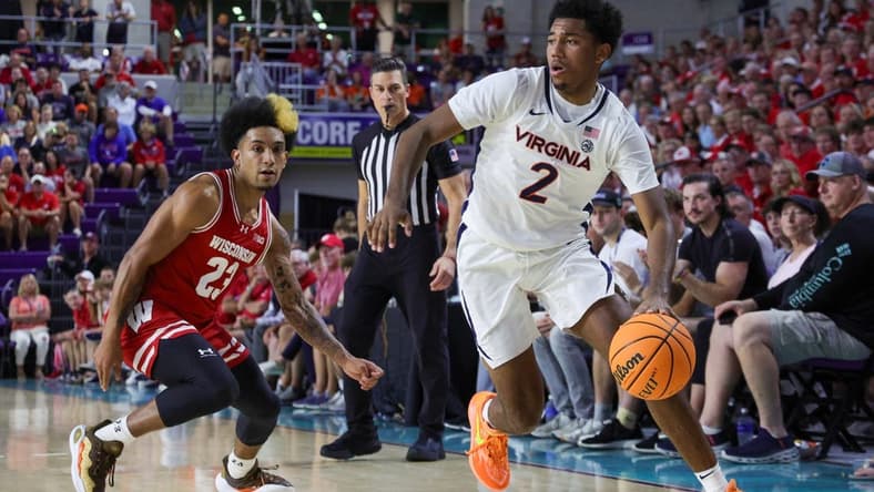 Nov 20, 2023; Fort Myers, Florida, USA;  Virginia Cavaliers guard Reece Beekman (2) moves the ball past Wisconsin Badgers guard Chucky Hepburn (23) in the first half during the Fort Myers Top-Off at Suncoast Credit Union Arena. Mandatory Credit: Nathan Ray Seebeck-USA TODAY Sports