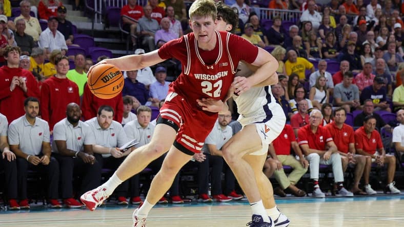 Nov 20, 2023; Fort Myers, Florida, USA;  Wisconsin Badgers forward Steven Crowl (22) drives to the basket past Virginia Cavaliers forward Blake Buchanan (0) in the second half during the Fort Myers Top-Off at Suncoast Credit Union Arena. Mandatory Credit: Nathan Ray Seebeck-USA TODAY Sports