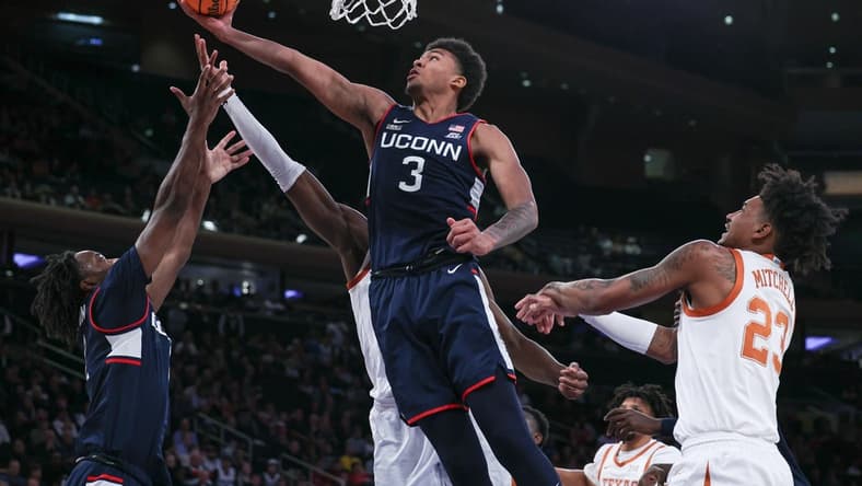 Nov 20, 2023; New York, NY, USA; Connecticut Huskies forward Jaylin Stewart (3) and guard Tristen Newton (2) rebound against Texas Longhorns forward Ze'Rik Onyema (21) and forward Dillon Mitchell (23) during the first half of the Empire Classic championship game at Madison Square Garden. Mandatory Credit: Vincent Carchietta-USA TODAY Sports