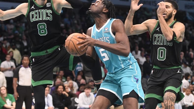 Nov 20, 2023; Charlotte, North Carolina, USA; Charlotte Hornets Center Mark Williams (5) looks to shoot as he is defended by Boston Celtics forward center Kristaps Porzingis (8) and forward Jayson Tatum (0) during the second half at the Spectrum Center. Mandatory Credit: Sam Sharpe-USA TODAY Sports