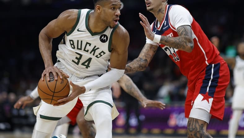 Nov 20, 2023; Washington, District of Columbia, USA; Milwaukee Bucks forward Giannis Antetokounmpo (34) drives to the basket as Washington Wizards forward Kyle Kuzma (33) defends in the fourth quarter at Capital One Arena. Mandatory Credit: Geoff Burke-USA TODAY Sports