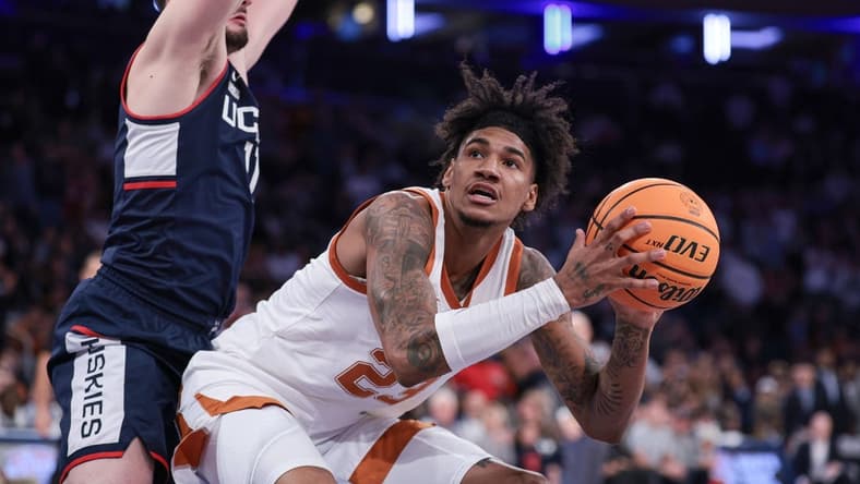 Nov 20, 2023; New York, NY, USA; Texas Longhorns forward Dillon Mitchell (23) drives to the basket against Connecticut Huskies forward Alex Karaban (11) during the second half of the Empire Classic championship game at Madison Square Garden. Mandatory Credit: Vincent Carchietta-USA TODAY Sports